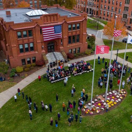 The Springfield College community participates in Veterans Day Observance on the steps of Marsh Memorial Hall 